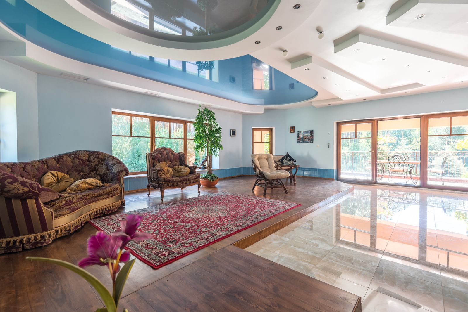 Bright, spacious living room with a clean modern multi-level ceiling and large windows